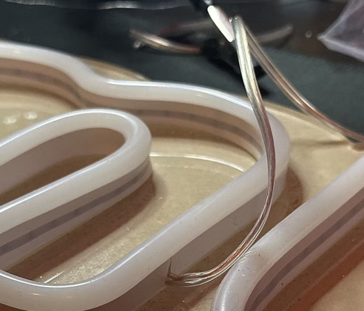 LED neon flex being laid into a sign's channels
